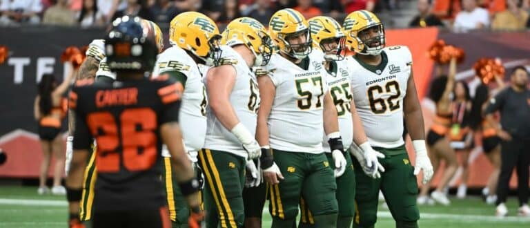 Edmonton Elks talk prior to play during the first half against the BC Lions at BC Place Stadium.