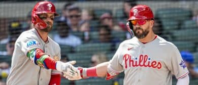 Philadelphia Phillies left fielder Kyle Schwarber (right) reacts with first baseman Bryce Harper (3) after hitting a home run against the Atlanta Braves during the eighth inning at Truist Park