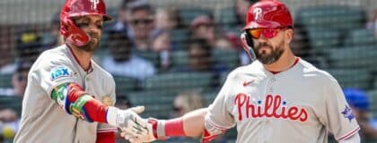 Philadelphia Phillies left fielder Kyle Schwarber (right) reacts with first baseman Bryce Harper (3) after hitting a home run against the Atlanta Braves during the eighth inning at Truist Park