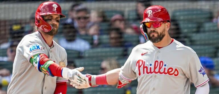 Philadelphia Phillies left fielder Kyle Schwarber (right) reacts with first baseman Bryce Harper (3) after hitting a home run against the Atlanta Braves during the eighth inning at Truist Park