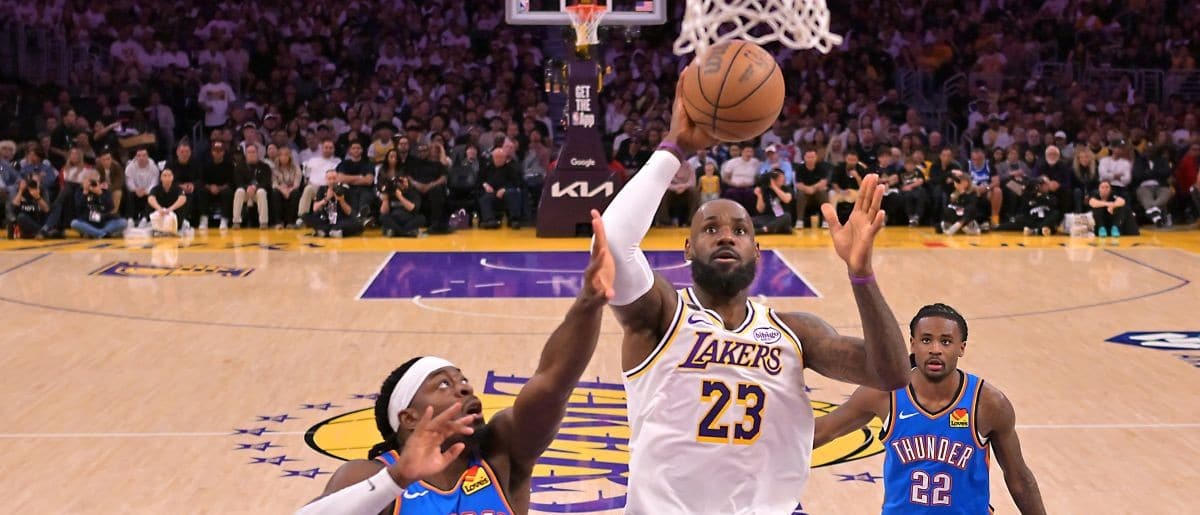 Los Angeles Lakers forward LeBron James (23) drives past Oklahoma City Thunder guard Luguentz Dort (5) during game three of the second round of the 2026 NBA Playoffs at Crypto.com Arena.