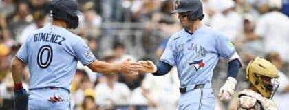 Toronto Blue Jays second baseman Ernie Clement (22) is congratulated by shortstop Andrés Giménez (0) after hitting a two-run home run during the fourth inning against the San Diego Padres at Petco Park.