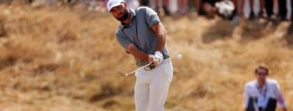 Scottie Scheffler prepares to play a chip shot on the first fairway during the third round of The Open Championship golf tournament at Royal Birkdale.