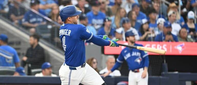 Toronto Blue Jays designated hitter George Springer (4) hits a single against the Tampa Bay Rays in the third inning at Rogers Centre.