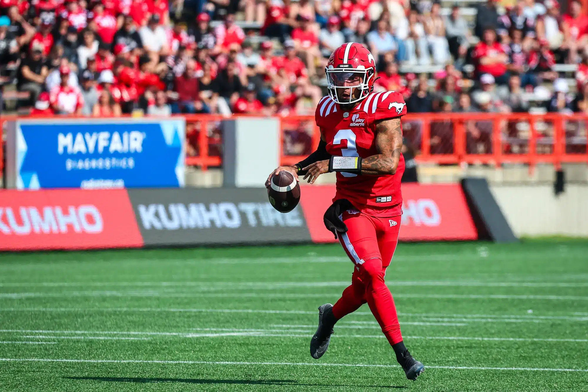 Jun 7, 2025; Calgary, Alberta, Canada; Calgary Stampeders quarterback Vernon Adams Jr (3) runs with the ball against the Hamilton Tiger-Cats during the first half at McMahon Stadium.