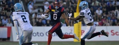 Montreal Alouettes wide receiver Tyson Philpot (6) runs with the ball and Toronto Argonauts defensive back Tarvarus McFadden (2) gives pursuit with teammate linebacker Donald Rutledge (38) during the first half at Percival-Molson stadium.