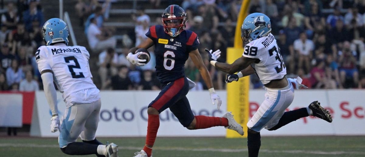 Montreal Alouettes wide receiver Tyson Philpot (6) runs with the ball and Toronto Argonauts defensive back Tarvarus McFadden (2) gives pursuit with teammate linebacker Donald Rutledge (38) during the first half at Percival-Molson stadium.