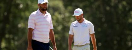 Scottie Scheffler and Wyndham Clark setup their play on the second green during the final round of the U.S. Open golf tournament at Shinnecock Hills Golf Club.