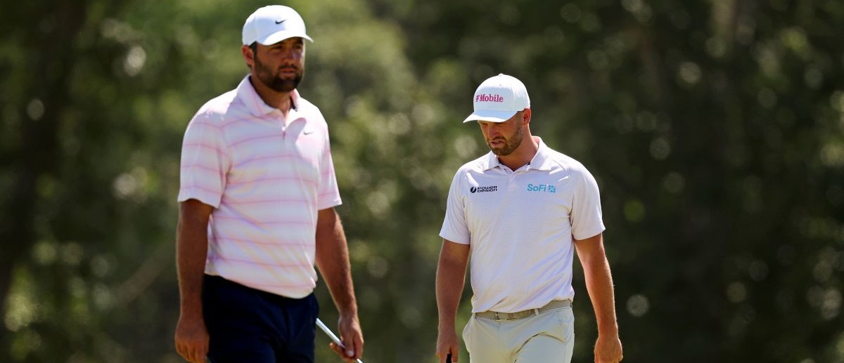 Scottie Scheffler and Wyndham Clark setup their play on the second green during the final round of the U.S. Open golf tournament at Shinnecock Hills Golf Club.