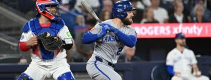 Kansas City Royals center fielder Kyle Isbel (28) hits a single as Toronto Blue Jays catcher Alejandro Kirk (30) looks on in the ninth inning at Rogers Centre.