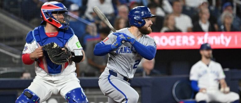 Kansas City Royals center fielder Kyle Isbel (28) hits a single as Toronto Blue Jays catcher Alejandro Kirk (30) looks on in the ninth inning at Rogers Centre.