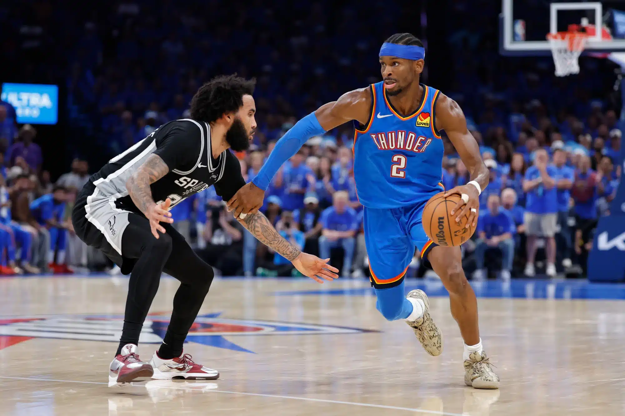 May 30, 2026; Oklahoma City, Oklahoma, USA; Oklahoma City Thunder guard Shai Gilgeous-Alexander (2) controls the ball against San Antonio Spurs forward Julian Champagnie (30) in the fourth quarter during game seven of the western conference finals for the 2026 NBA playoffs at Paycom Center.