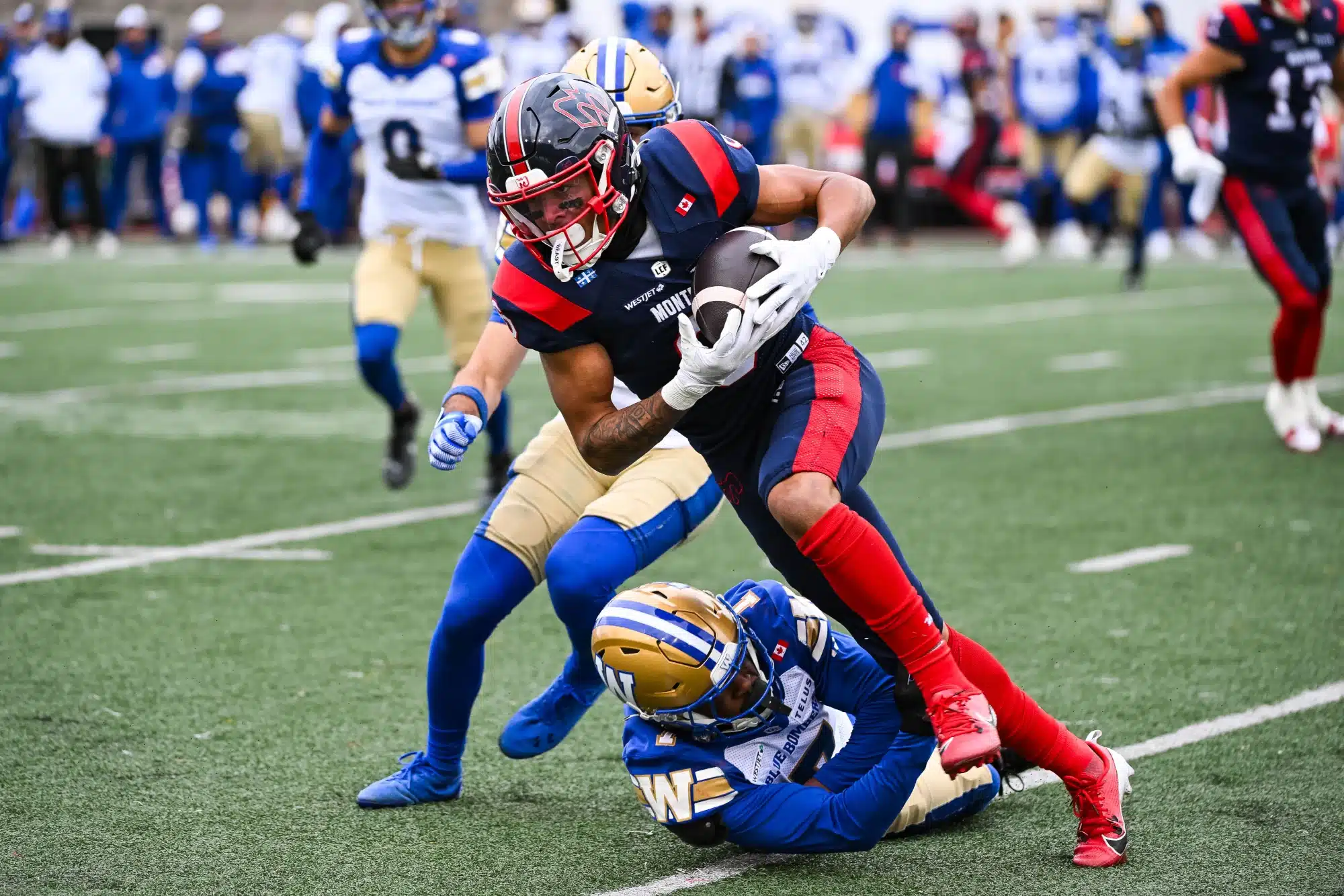Montreal, Quebec, Canada; Montreal Alouettes wide receiver Tyson Philpot (6) gets tackled by Winnipeg Blue Bombers defensive back Jamal Parker (7) during the second quarter at Percival-Molson stadium.