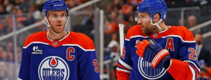 Edmonton Oilers forward Connor McDavid (97) and forward Leon Draisaitl (29) discuss a play during a break in play against the Seattle Kraken at Rogers Place. Mandatory Credit: Perry Nelson-Imagn Images