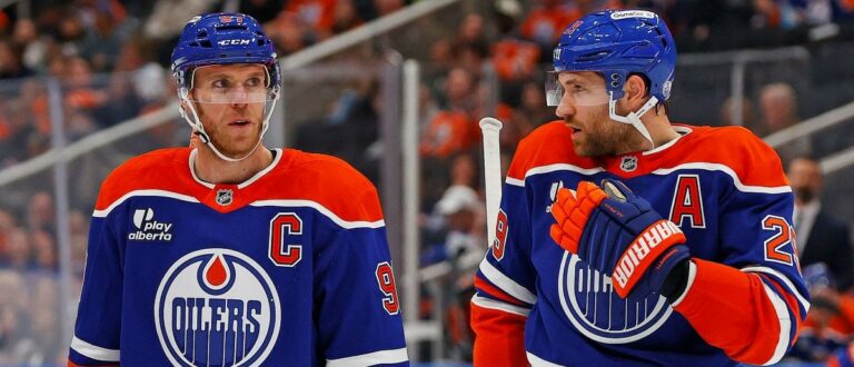 Edmonton Oilers forward Connor McDavid (97) and forward Leon Draisaitl (29) discuss a play during a break in play against the Seattle Kraken at Rogers Place. Mandatory Credit: Perry Nelson-Imagn Images