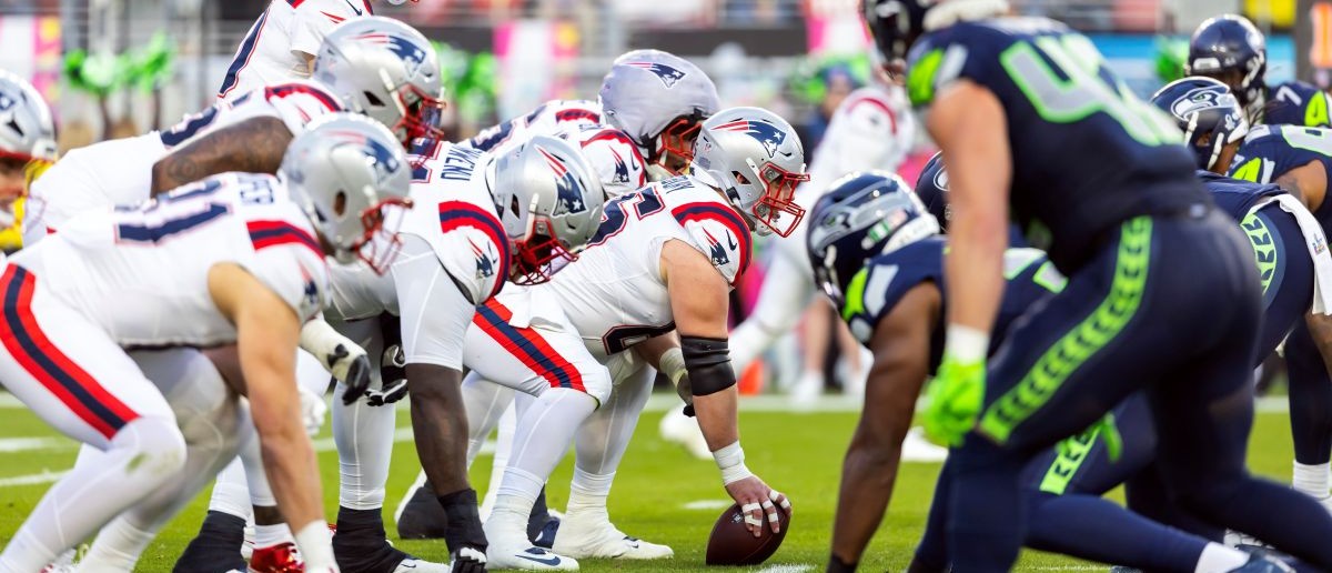 New England Patriots center Garrett Bradbury (65) prepares to snap the ball to quarterback Drake Maye (10) against the Seattle Seahawks during Super Bowl LX at Levi's Stadium.