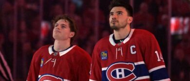 Montreal Canadiens forward Cole Caufield (13) and teammate forward Nick Suzuki (14) during the National Anthem before the game against the Florida Panthers at the Bell Centre. Mandatory Credit: Eric Bolte-Imagn Images