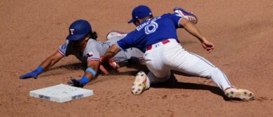 Toronto Blue Jays shortstop Andres Gimenez (0) catches Texas Rangers second baseman Nicky Lopez (33) trying to steal second base during the eighth inning at Rogers Centre. Mandatory Credit: John E. Sokolowski-Imagn Images