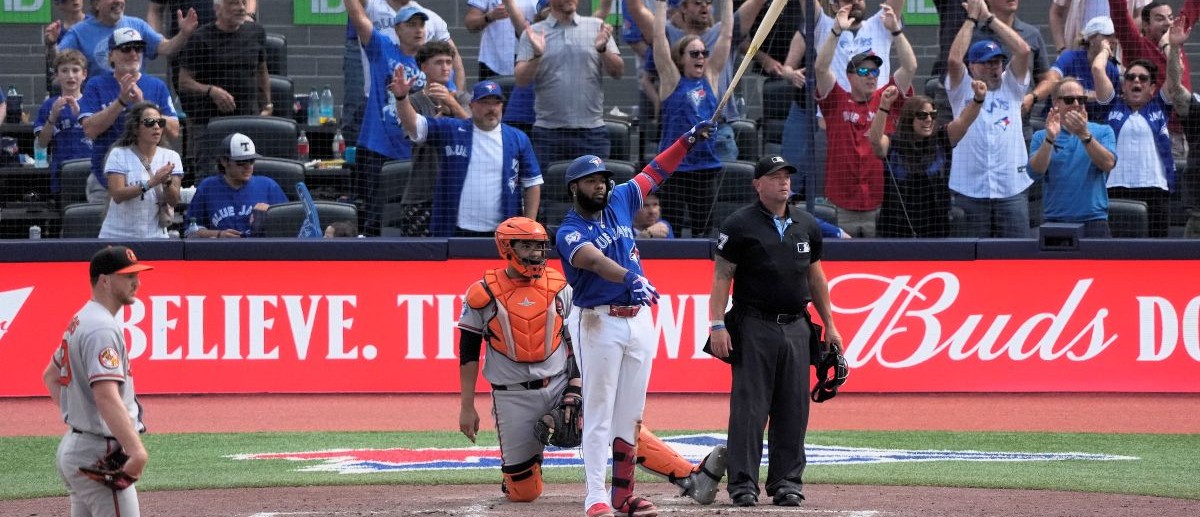 Toronto Blue Jays first baseman Vladimir Guerrero Jr. (27) watches his first home run of the season at Rogers Centre go over the the left field wall during the fifth inning against the Baltimore Orioles. Mandatory Credit: John E. Sokolowski-Imagn Images