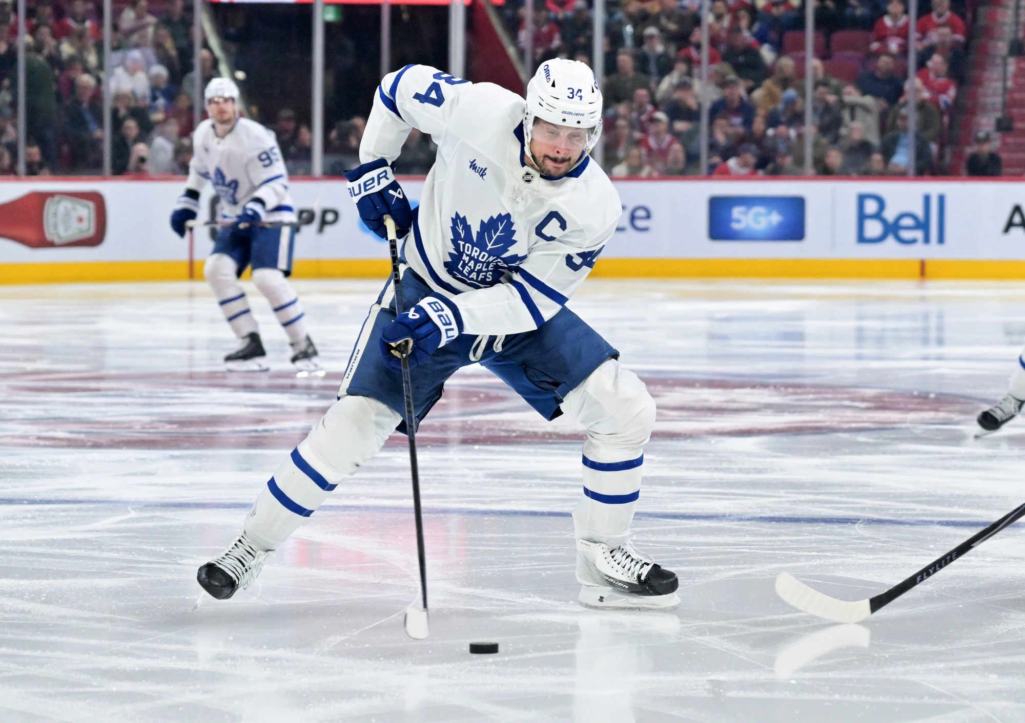 Mar 10, 2026; Montreal, Quebec, CAN; Toronto Maple Leafs forward Auston Matthews (34) plays the puck during the third period against the Montreal Canadiens at the Bell Centre.