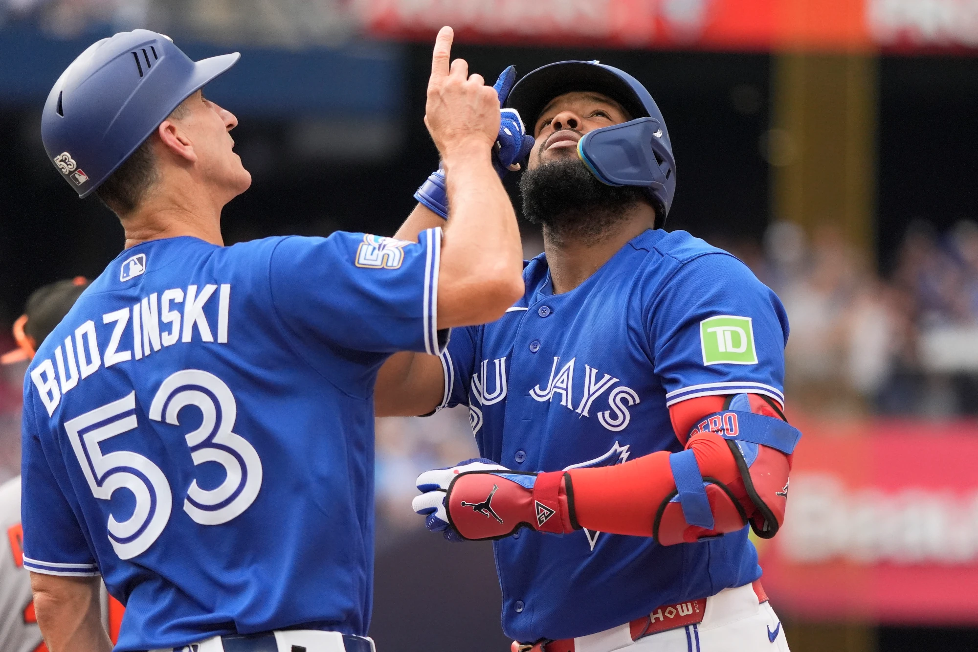 Sep 13, 2026; Toronto, Ontario, CAN; Toronto Blue Jays first base coach Mark Budzinski and first baseman Vladimir Guerrero Jr. (27) point skyward after Vladdie's single against the Baltimore Orioles during the eighth inning at Rogers Centre. 