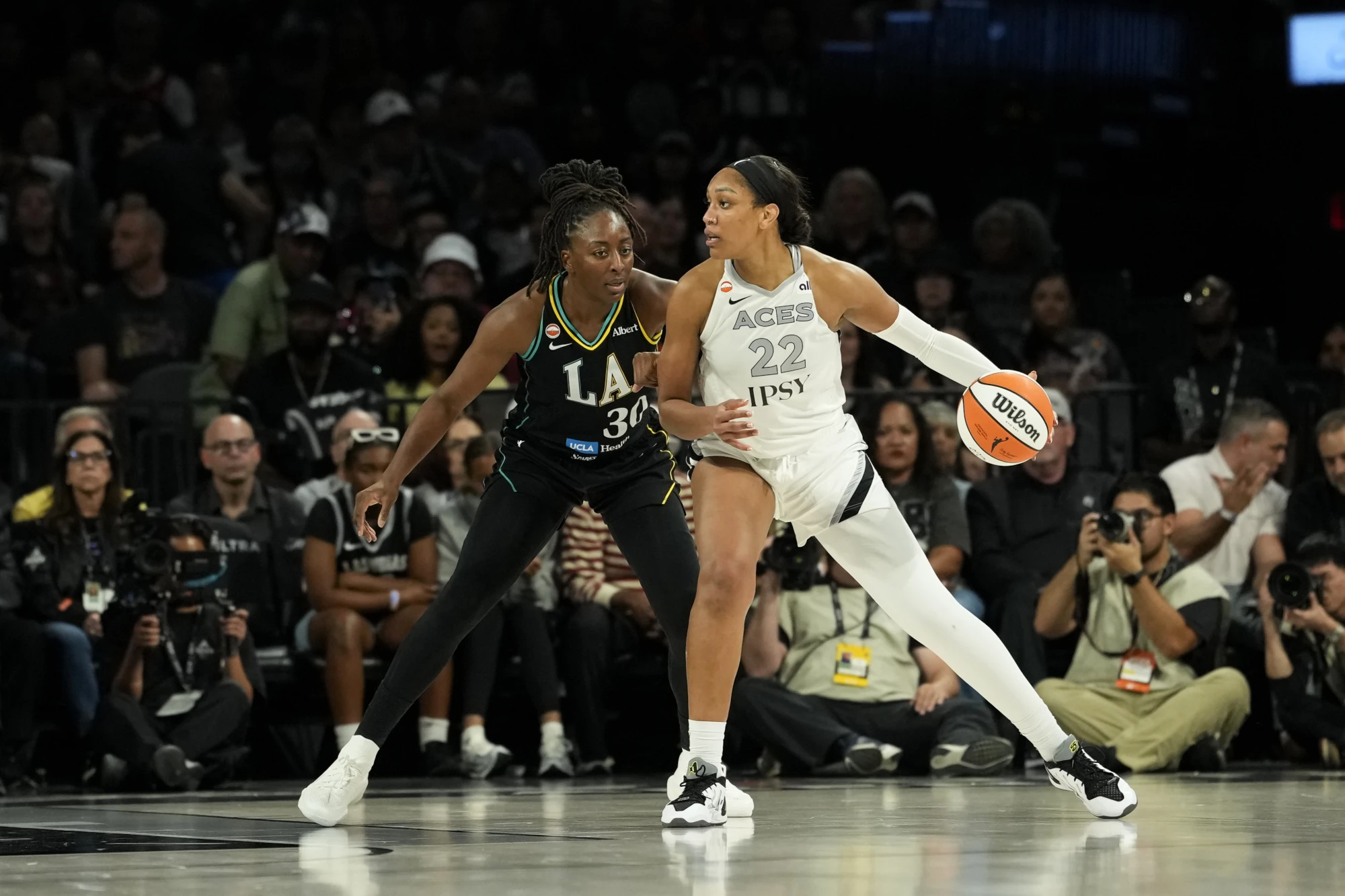 Las Vegas Aces center A'ja Wilson (22) controls the ball against Los Angeles Sparks forward Nneka Ogwumike (30) during the fourth quarter of a WNBA basketball game at Michelob Ultra Arena. Mandatory Credit: Lucas Peltier-Imagn Images. Sep 22, 2026; Las Vegas, Nevada, USA.