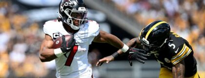 Atlanta Falcons running back Bijan Robinson (7) scores a touchdown against Pittsburgh Steelers cornerback Jalen Ramsey (5) during the first quarter at Acrisure Stadium. Mandatory Credit: Barry Reeger-Imagn Images