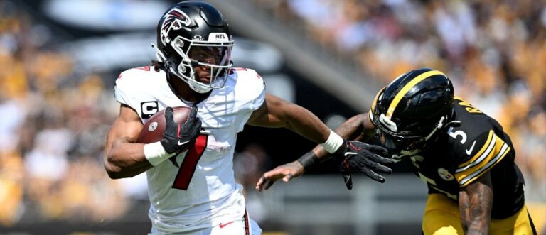 Atlanta Falcons running back Bijan Robinson (7) scores a touchdown against Pittsburgh Steelers cornerback Jalen Ramsey (5) during the first quarter at Acrisure Stadium. Mandatory Credit: Barry Reeger-Imagn Images
