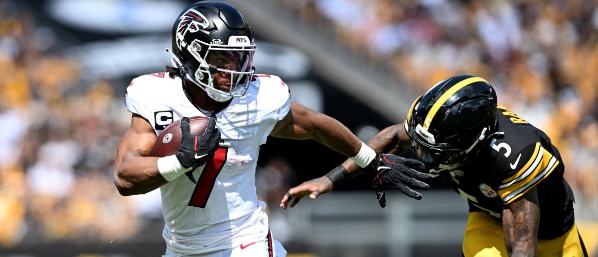 Atlanta Falcons running back Bijan Robinson (7) scores a touchdown against Pittsburgh Steelers cornerback Jalen Ramsey (5) during the first quarter at Acrisure Stadium. Mandatory Credit: Barry Reeger-Imagn Images