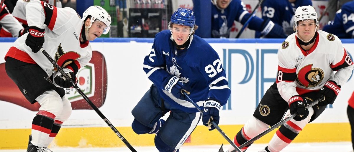 Toronto Maple Leafs forward Gavin McKenna (92) is tripped by the stick of Ottawa Senators forward Philippe Daoust (92) as forward Kasperi Halttunen (68) skates by in the third period at Scotiabank Arena. Mandatory Credit: Dan Hamilton-Imagn Images