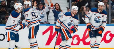 Edmonton Oilers forward Leon Draisaitl (29) celebrates his goal with forward Kasperi Kapanen (42) and defenseman Evan Bouchard (2) and forward Connor McDavid (97) and forward Vasily Podkolzin (92) against the Vancouver Canucks in the third period at Rogers Arena. Mandatory Credit: Bob Frid-Imagn Images