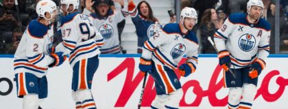 Edmonton Oilers forward Leon Draisaitl (29) celebrates his goal with forward Kasperi Kapanen (42) and defenseman Evan Bouchard (2) and forward Connor McDavid (97) and forward Vasily Podkolzin (92) against the Vancouver Canucks in the third period at Rogers Arena. Mandatory Credit: Bob Frid-Imagn Images