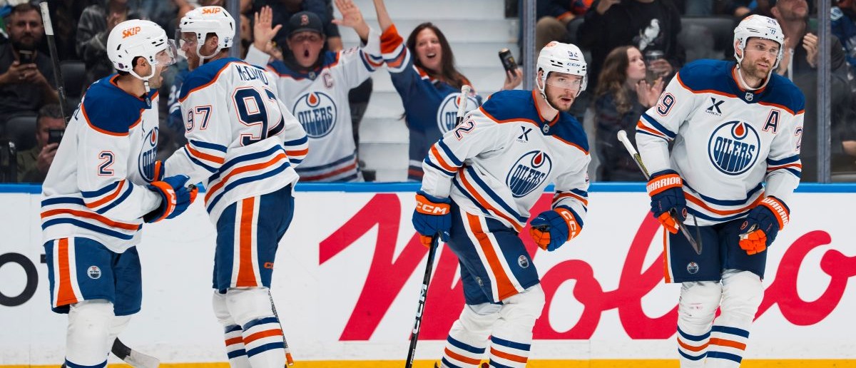 Edmonton Oilers forward Leon Draisaitl (29) celebrates his goal with forward Kasperi Kapanen (42) and defenseman Evan Bouchard (2) and forward Connor McDavid (97) and forward Vasily Podkolzin (92) against the Vancouver Canucks in the third period at Rogers Arena. Mandatory Credit: Bob Frid-Imagn Images