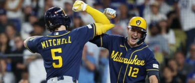 Milwaukee Brewers outfielder Garrett Mitchell (5) celebrates with shortstop Cooper Pratt (12) after a home run against the Los Angeles Dodgers during the seventh inning in game three of the NLCS for the 2026 MLB Playoffs at Uniqlo Field at Dodger Stadium. Mandatory Credit: Kiyoshi Mio-Imagn Images