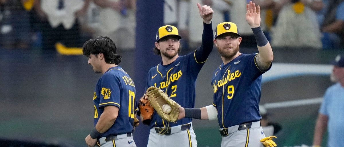 Milwaukee Brewers players Brice Turang (2) and Jake Bauers (9) signal that Milwaukee Brewers right fielder Sal Frelick (10) is okay after making a diving catch against the Tampa Bay Rays during the eighth inning during Game 3 of the World Series at Tropicana Field in St. Petersburg, Fla. on Oct 26, 2026