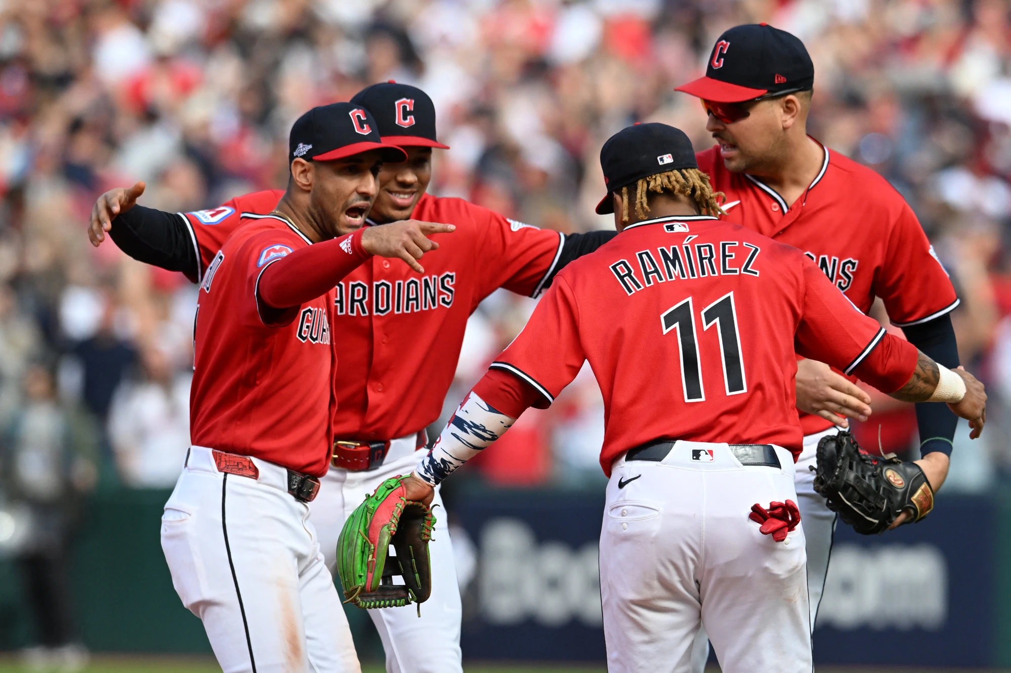 Oct 15, 2026; Cleveland, Ohio, USA; Cleveland Guardians shortstop Brayan Rocchio (4), second baseman Angel Genao (17), third baseman Jose Ramirez (11) and first baseman Nathaniel Lowe (46) celebrate a win against the Tampa Bay Rays in game three of the ALCS for the 2026 MLB Playoffs at Progressive Field. 